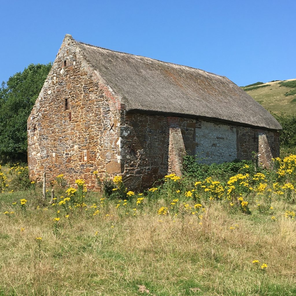 Stone barn with a thatched roof