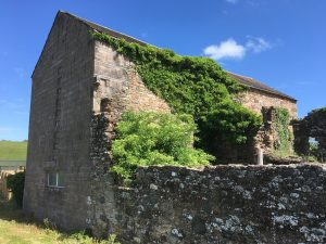 An uncovered stone barn